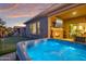 Spacious hot tub with outdoor fireplace and putting green at 16480 W Catalina Dr, Goodyear, AZ 85395