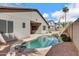 Backyard with a private pool, rock features, desert landscaping, and covered patio area at 1699 E Hearne Way, Gilbert, AZ 85234