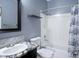 Bathroom featuring a granite countertop vanity, framed mirror, and a shower/tub combination at 1699 E Hearne Way, Gilbert, AZ 85234