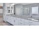 Bright bathroom featuring double sinks, granite counters, white cabinets, and tile flooring at 1699 E Hearne Way, Gilbert, AZ 85234
