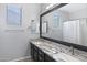 Double vanity bathroom with granite countertops, framed mirror, and modern fixtures at 1699 E Hearne Way, Gilbert, AZ 85234