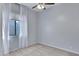 Cozy bedroom with carpet, ceiling fan, and a window dressed with sheer curtains at 1699 E Hearne Way, Gilbert, AZ 85234