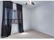 Bright, carpeted bedroom featuring a large window with dark curtains and neutral wall paint at 1699 E Hearne Way, Gilbert, AZ 85234