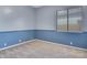 Carpeted bedroom with two-tone walls, a window with blinds, and ample natural light at 1699 E Hearne Way, Gilbert, AZ 85234