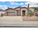 Charming single-story home featuring a three-car garage and desert landscaping with cacti and gravel at 1699 E Hearne Way, Gilbert, AZ 85234