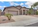 Charming single-story home featuring a three-car garage and desert landscaping with cacti and gravel at 1699 E Hearne Way, Gilbert, AZ 85234