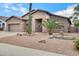 Charming single-story home featuring a three-car garage and desert landscaping with cacti and gravel at 1699 E Hearne Way, Gilbert, AZ 85234