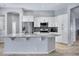 Bright kitchen features white cabinets, stainless steel appliances, granite counters, and a large center island at 1699 E Hearne Way, Gilbert, AZ 85234