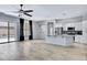 Open-concept living area with tile floors, a ceiling fan, and a view of the backyard pool at 1699 E Hearne Way, Gilbert, AZ 85234