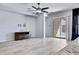 Bright open-concept living room with neutral walls, sliding glass doors, tile flooring, and a ceiling fan at 1699 E Hearne Way, Gilbert, AZ 85234