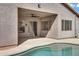 Covered patio with ceiling fan overlooks a sparkling pool, offering a seamless indoor-outdoor living experience at 1699 E Hearne Way, Gilbert, AZ 85234