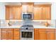 Modern kitchen features stainless steel appliances and wood cabinets at 18747 N Sunsites Dr, Surprise, AZ 85387