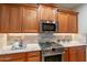 Up-to-date kitchen featuring stainless steel appliances, tile backsplash, and light granite countertops at 18747 N Sunsites Dr, Surprise, AZ 85387