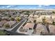 Spectacular aerial view of a home nestled in a vibrant neighborhood with well-maintained streets and manicured lawns at 18906 E Cattle Dr, Queen Creek, AZ 85142