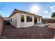 Landscaped backyard with gravel, desert plants, and exterior view of the covered patio at 18906 E Cattle Dr, Queen Creek, AZ 85142