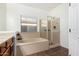 Bright bathroom featuring a soaking tub, a walk-in shower, and tile flooring at 18906 E Cattle Dr, Queen Creek, AZ 85142