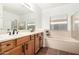Well-lit bathroom features double vanity, separate soaking tub, and walk-in shower at 18906 E Cattle Dr, Queen Creek, AZ 85142