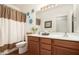 Well-lit bathroom with a double vanity, neutral decor, and a shower-tub combination at 18906 E Cattle Dr, Queen Creek, AZ 85142