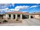 Charming single-story home showcasing a manicured front yard, a two-car garage, and a welcoming facade at 18906 E Cattle Dr, Queen Creek, AZ 85142
