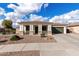 Charming single-story home with a well-maintained front yard and a two-car garage at 18906 E Cattle Dr, Queen Creek, AZ 85142