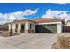 Well-maintained single-story home with desert landscaping and a two-car garage at 18906 E Cattle Dr, Queen Creek, AZ 85142