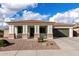 Charming single-story home with a well-maintained front yard and a two-car garage at 18906 E Cattle Dr, Queen Creek, AZ 85142