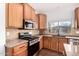 This kitchen has light wood cabinets, granite countertops, and stainless steel appliances at 18906 E Cattle Dr, Queen Creek, AZ 85142