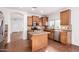 Spacious kitchen with stainless appliances, center island, tile flooring, and granite countertops at 18906 E Cattle Dr, Queen Creek, AZ 85142
