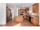 Open kitchen features an island, granite countertops, stainless appliances, and wood cabinets at 18906 E Cattle Dr, Queen Creek, AZ 85142