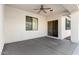 Enjoy this covered patio with a ceiling fan, perfect for outdoor dining or relaxing at 18906 E Cattle Dr, Queen Creek, AZ 85142