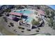 Aerial view of a community pool area with covered seating and well-maintained landscaping in a residential neighborhood at 18906 E Cattle Dr, Queen Creek, AZ 85142