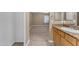 Neutral bathroom with granite countertop vanity leading into a large bedroom at 2025 E Campbell Ave # 140, Phoenix, AZ 85016