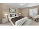 Relaxing primary bedroom featuring carpet, an accent chair, and a large bed with white bedding at 2025 E Campbell Ave # 140, Phoenix, AZ 85016