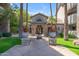 A sidewalk lined by two palm trees leading to the community clubhouse at 2025 E Campbell Ave # 140, Phoenix, AZ 85016