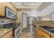 Bright kitchen boasts stainless steel appliances and open layout to living area at 2025 E Campbell Ave # 140, Phoenix, AZ 85016