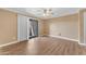 View of the bright living room with hardwood floors, ceiling fan and sliding glass door at 2025 E Campbell Ave # 140, Phoenix, AZ 85016