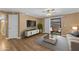 Bright living room features hardwood floors, sliding glass doors to balcony, and neutral decor at 2025 E Campbell Ave # 140, Phoenix, AZ 85016