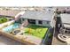 Aerial view of backyard featuring a pool, trampoline, manicured lawn, and seating area at 21716 E Waverly Dr, Queen Creek, AZ 85142