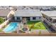 Aerial view of backyard featuring a pool, trampoline, manicured lawn, and seating area at 21716 E Waverly Dr, Queen Creek, AZ 85142