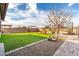 View of a backyard featuring artificial turf, desert landscaping, and a playset for outdoor activities at 21716 E Waverly Dr, Queen Creek, AZ 85142
