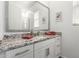 Modern bathroom with a spacious granite countertop, vanity, framed mirror, and a glass-enclosed shower at 21716 E Waverly Dr, Queen Creek, AZ 85142