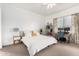 Cozy bedroom with a comfortable bed, neutral walls, and a functional workspace at 21716 E Waverly Dr, Queen Creek, AZ 85142