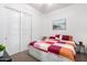 Bright bedroom featuring a colorful bedspread, closet with sliding doors, and neutral carpet at 21716 E Waverly Dr, Queen Creek, AZ 85142