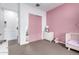 Comfortable bedroom with a pink accent wall, soft carpet, and access to the ensuite at 21716 E Waverly Dr, Queen Creek, AZ 85142