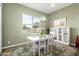 Charming dining room with a white table and chairs, modern chandelier, and natural light at 21716 E Waverly Dr, Queen Creek, AZ 85142