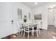 Bright dining room with a white table, neutral chairs, and a view of the front door at 21716 E Waverly Dr, Queen Creek, AZ 85142