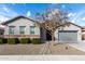 Charming single story home with gray exterior, low maintenance landscaping, and mature shade tree at 21716 E Waverly Dr, Queen Creek, AZ 85142