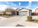 Beautiful single-Gathering home features a three-car garage, stone accents, and well-maintained landscaping at 21716 E Waverly Dr, Queen Creek, AZ 85142