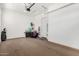 View of the garage with white walls and neutral floor with storage to the side and garage door opener at 21716 E Waverly Dr, Queen Creek, AZ 85142