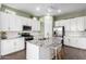 Well-equipped kitchen featuring granite counters, white cabinets, stainless steel appliances and a center island at 21716 E Waverly Dr, Queen Creek, AZ 85142